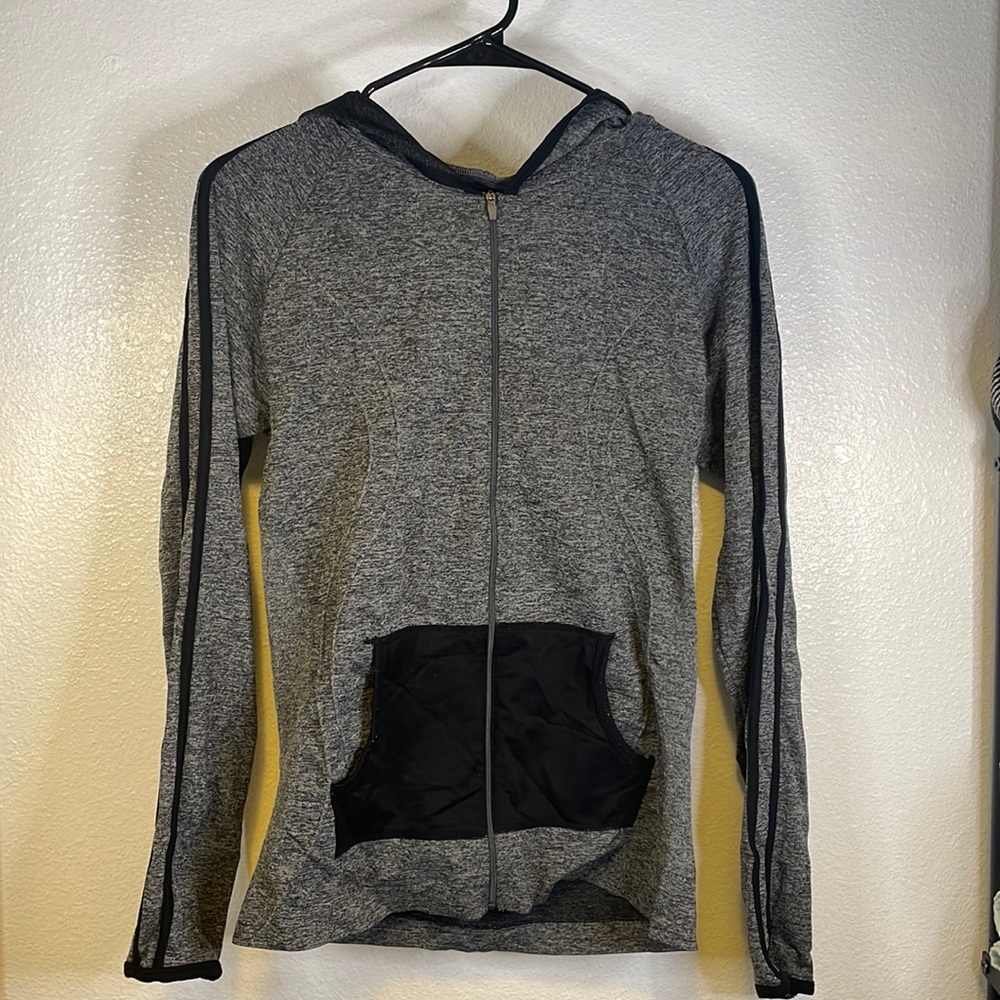 Zip up jacket with 3 strips on the sleeves.